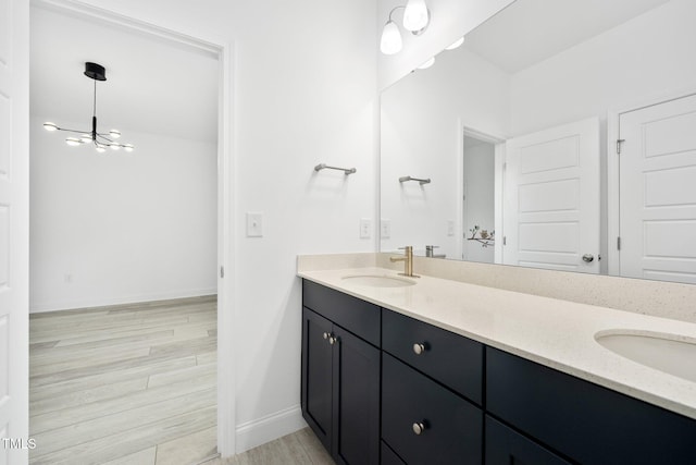 1813 Lost Creek Ct, Apex, NC 27539 - bathroom with double vanity, baseboards, wood finished floors, and a chandelier