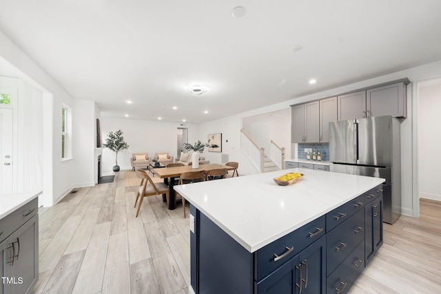 1813 Lost Creek Ct, Apex, NC 27539 - kitchen featuring freestanding refrigerator, light wood-type flooring, light countertops, a center island, and recessed lighting