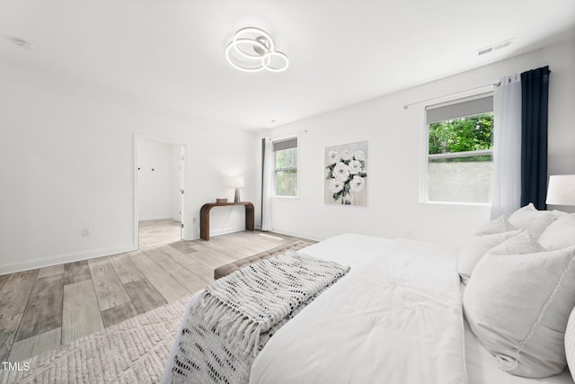 1813 Lost Creek Ct, Apex, NC 27539 - bedroom featuring wood finished floors, multiple windows, and baseboards