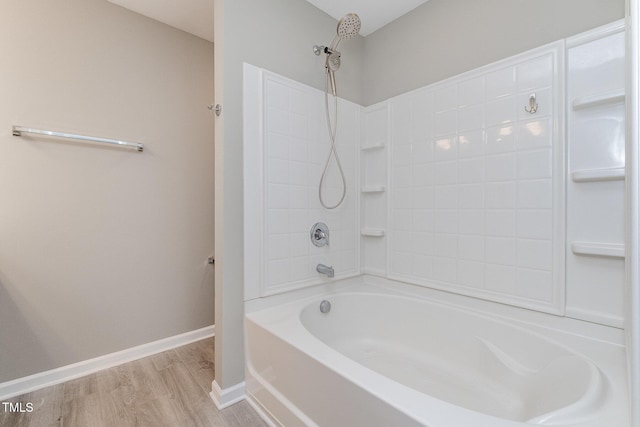 full bathroom featuring baseboards, shower / tub combination, and wood finished floors