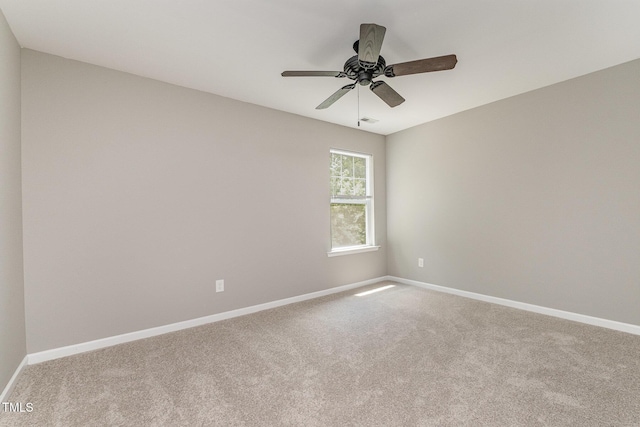 empty room featuring baseboards and carpet