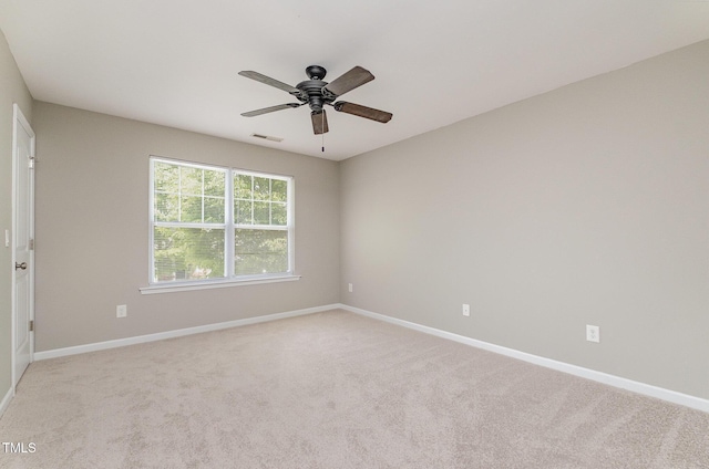 unfurnished room with visible vents, baseboards, and ceiling fan