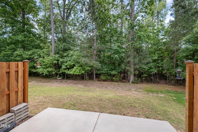 view of yard featuring fence and a patio