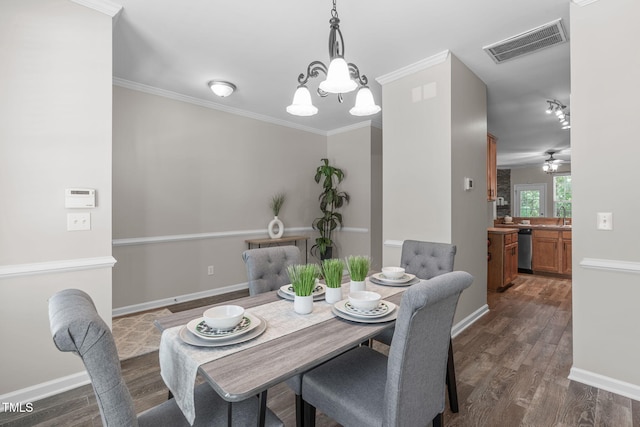 dining room with baseboards, ornamental molding, dark wood-style floors, and visible vents