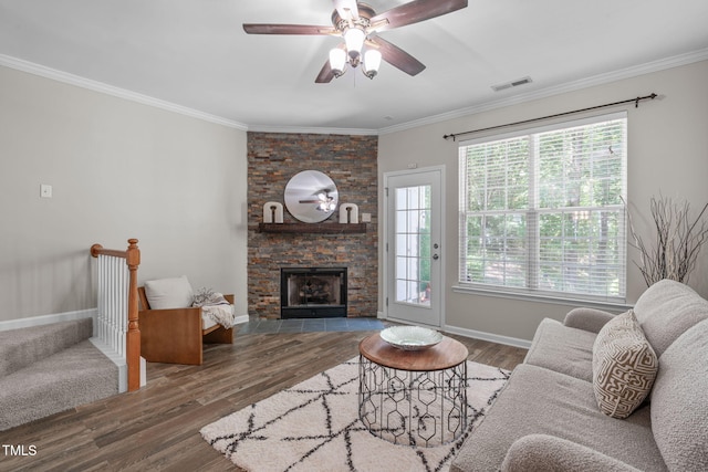living room with crown molding, ceiling fan, baseboards, wood finished floors, and visible vents