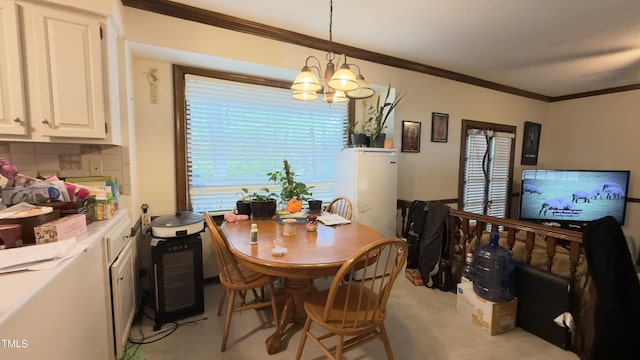 dining area with ornamental molding and a notable chandelier
