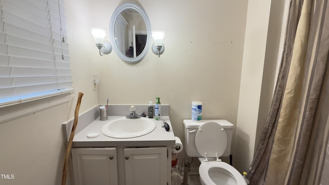 full bathroom featuring toilet and vanity