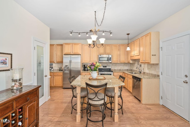 210 Presidents Walk Ln, Cary, NC 27519 - kitchen with light brown cabinetry, tasteful backsplash, a sink, stainless steel appliances, and light wood-type flooring