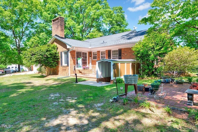 206 Kittys Ln, Erwin, NC 28339 - back of house featuring a chimney, a yard, a patio area, and brick siding