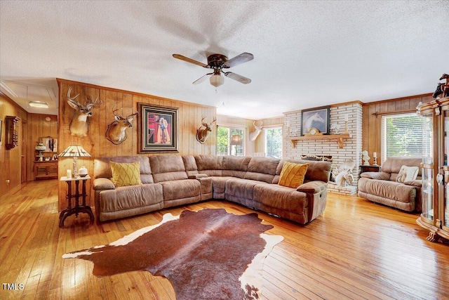 206 Kittys Ln, Erwin, NC 28339 - living area with wood-type flooring, a ceiling fan, a textured ceiling, and wood walls