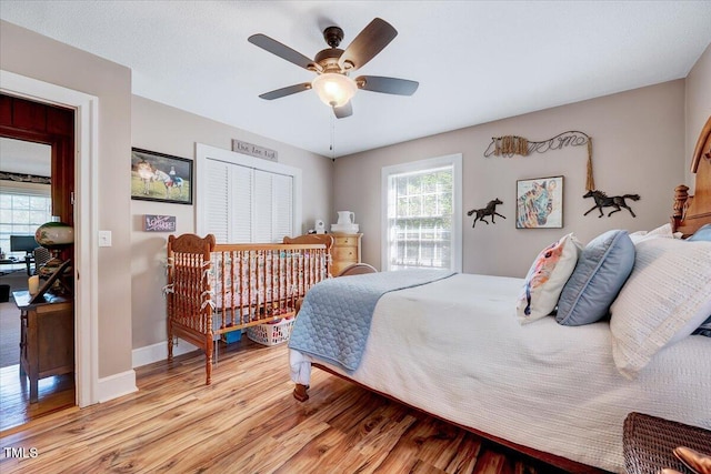 206 Kittys Ln, Erwin, NC 28339 - bedroom with a ceiling fan, baseboards, multiple windows, and light wood-type flooring