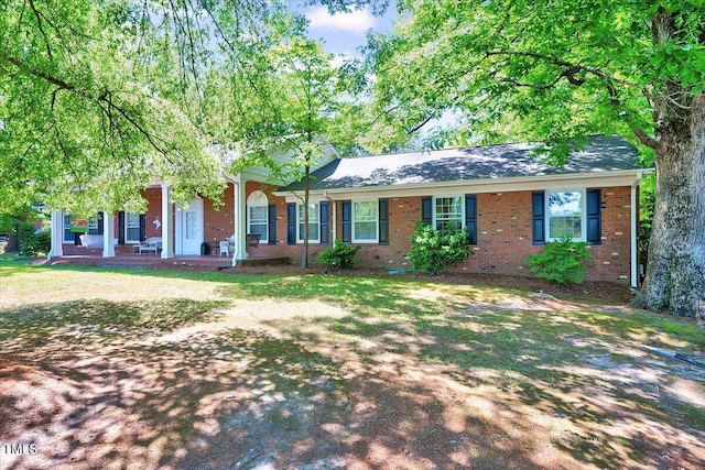 206 Kittys Ln, Erwin, NC 28339 - ranch-style home featuring a porch, brick siding, and a shingled roof