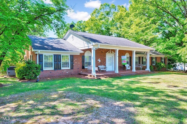 206 Kittys Ln, Erwin, NC 28339 - view of front of home with covered porch, brick siding, and a front yard