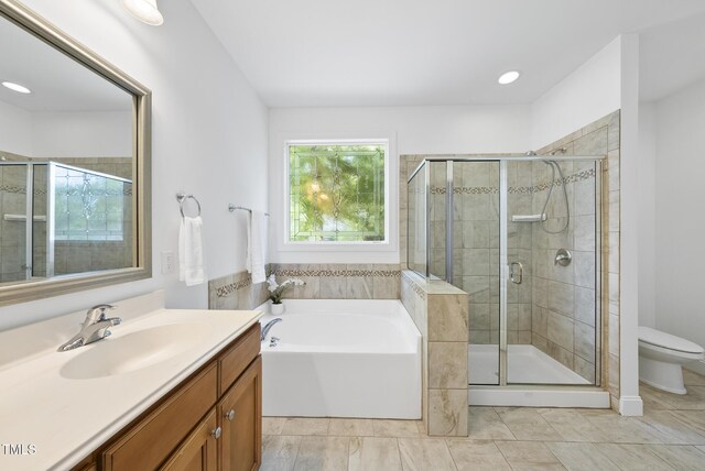 20 Paddy Ln, Youngsville, NC 27596 - full bathroom featuring vanity, a bath, toilet, and a shower stall