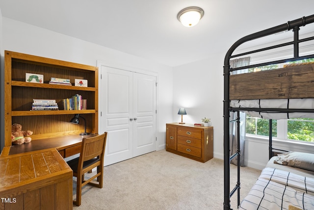 20 Paddy Ln, Youngsville, NC 27596 - bedroom with light colored carpet, a closet, a desk, and baseboards