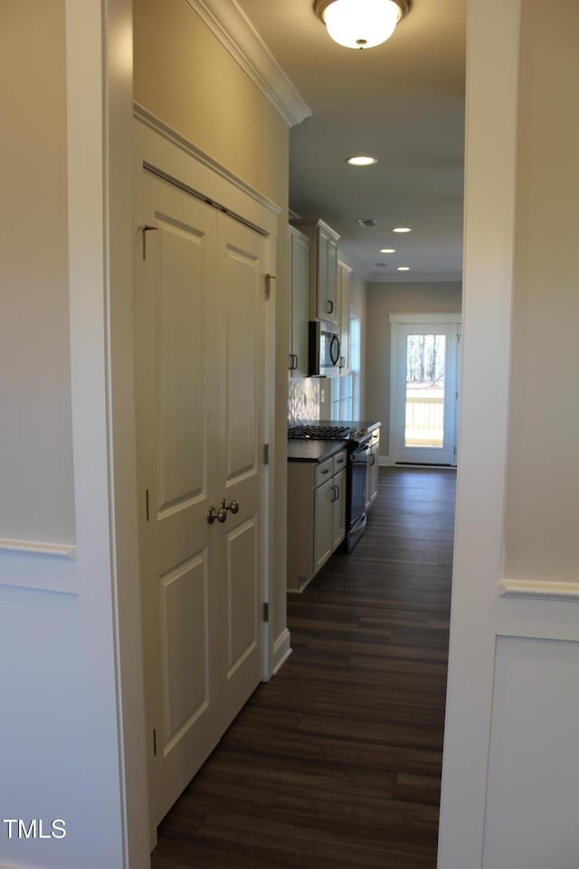 hallway featuring crown molding, dark wood-style flooring, and recessed lighting