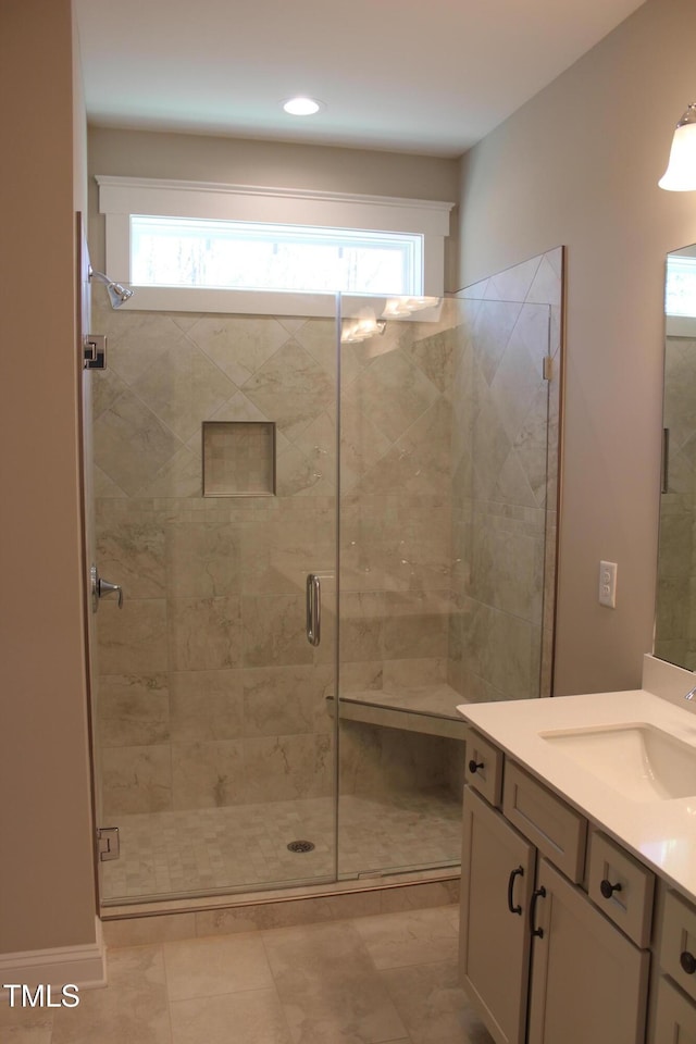 bathroom with vanity and a shower stall