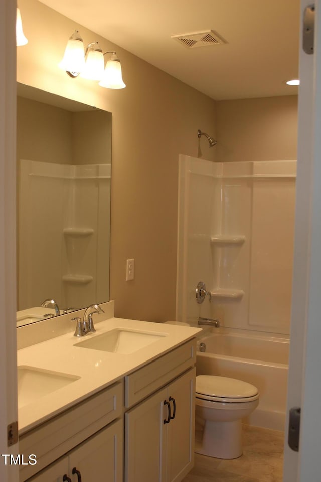 full bathroom with double vanity, toilet, visible vents, and a sink