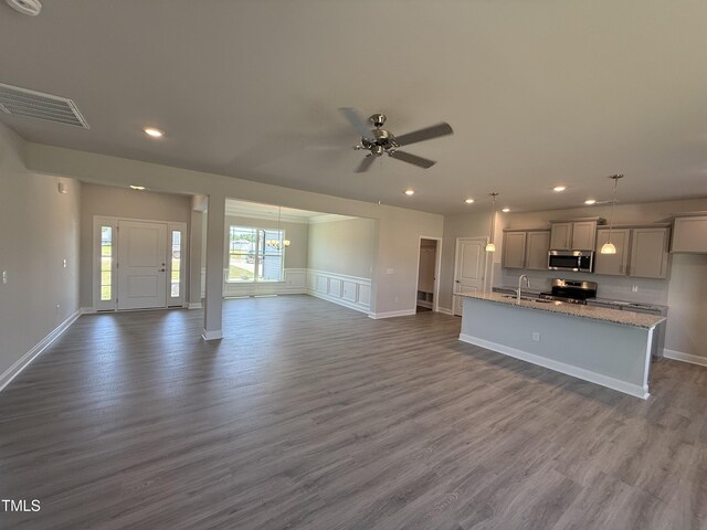 5084 Holly Hill Ct Lot 25, Battleboro, NC 27809 - unfurnished living room with dark wood-type flooring, ceiling fan with notable chandelier, recessed lighting, and visible vents