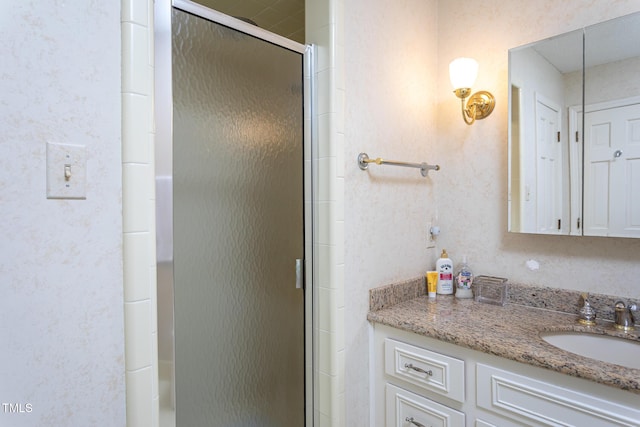 bathroom with vanity and a stall shower