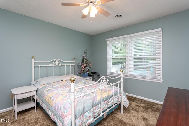 bedroom featuring carpet floors, baseboards, visible vents, and ceiling fan