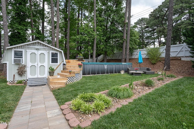 view of yard featuring a fenced backyard, a fenced in pool, an outbuilding, and a shed