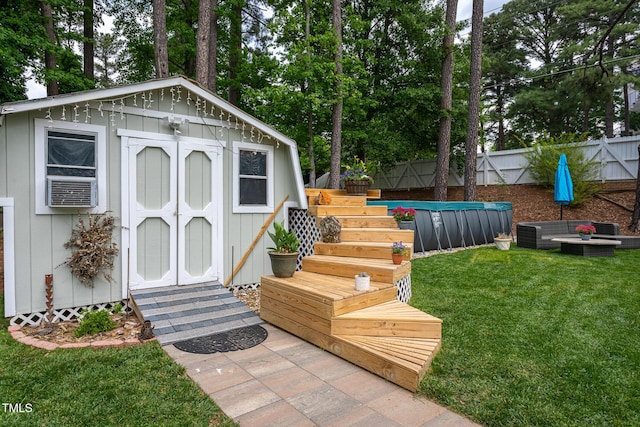 view of shed featuring a fenced in pool and a fenced backyard