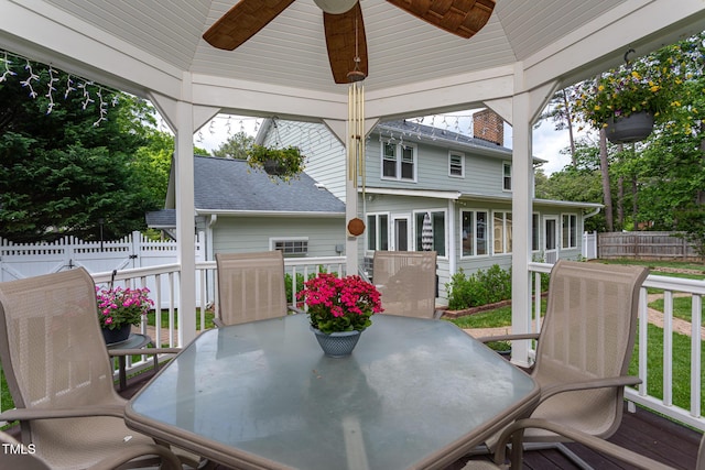 deck with ceiling fan, fence, and outdoor dining area