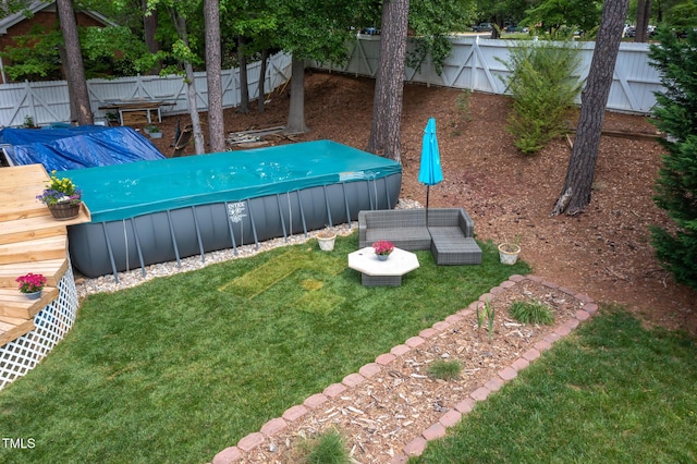 view of yard with a fenced backyard, a hot tub, and a deck
