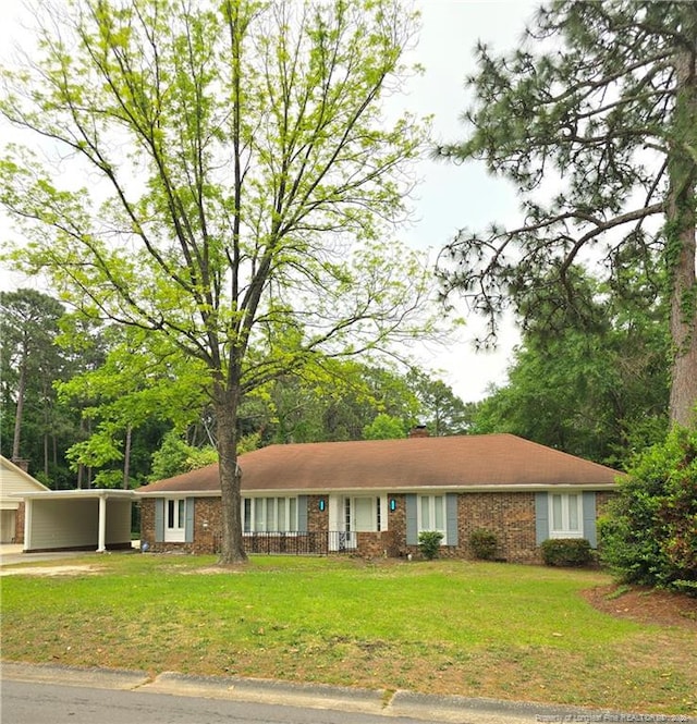 2513 Colgate Dr, Fayetteville, NC 28304 - single story home featuring a front yard, brick siding, and a carport