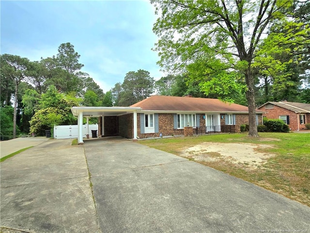 2513 Colgate Dr, Fayetteville, NC 28304 - ranch-style house featuring driveway, an attached carport, and a front lawn