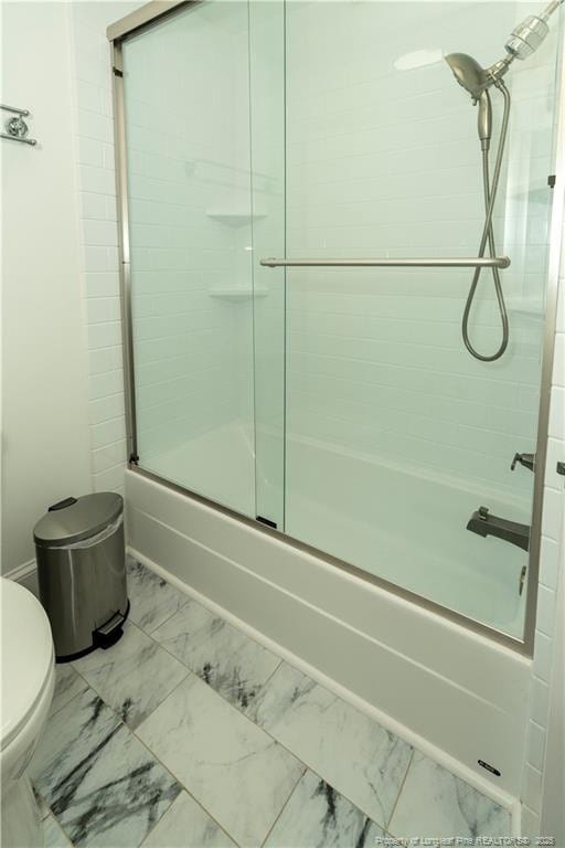 2513 Colgate Dr, Fayetteville, NC 28304 - bathroom featuring marble look tiles, toilet, and bath / shower combo with glass door