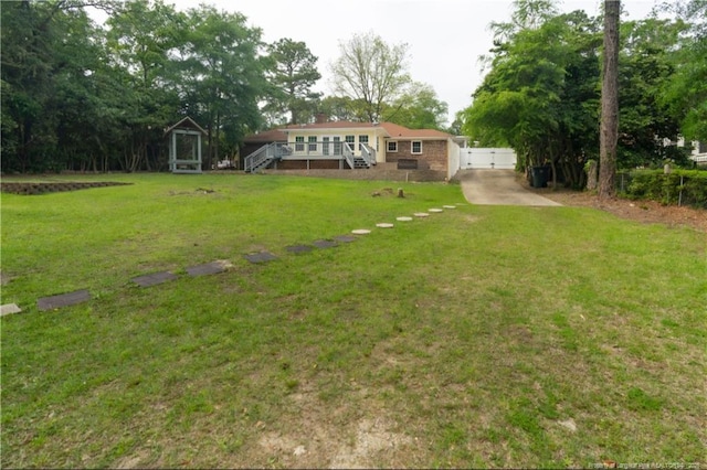 2513 Colgate Dr, Fayetteville, NC 28304 - view of green lawn with stairway and a deck