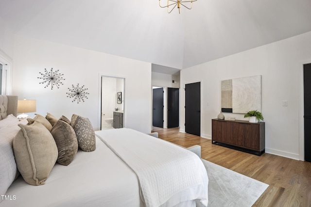 bedroom featuring ensuite bath, high vaulted ceiling, a chandelier, baseboards, and wood finished floors