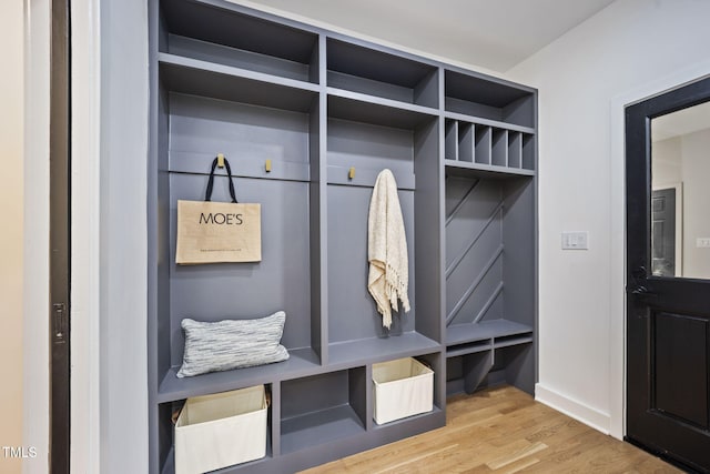 mudroom with baseboards and wood finished floors