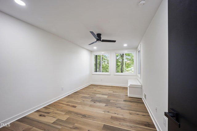 spare room with baseboards, a ceiling fan, recessed lighting, and wood finished floors