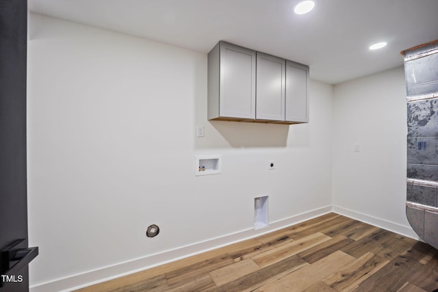 laundry room featuring wood finished floors, baseboards, cabinet space, electric dryer hookup, and washer hookup