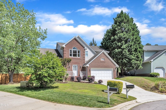 traditional-style home with brick siding, a garage, a front lawn, and fence