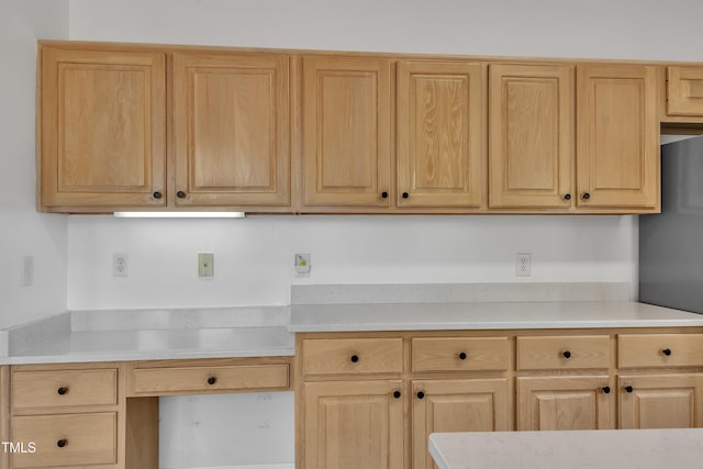 kitchen featuring light countertops and light brown cabinetry