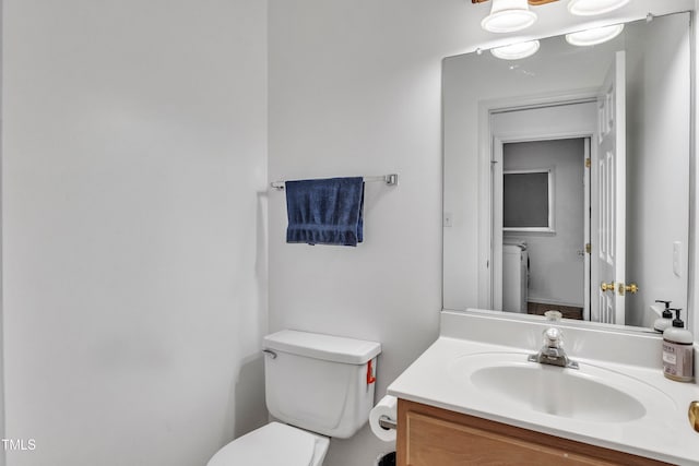 half bathroom with toilet and vanity