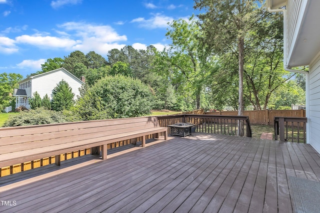 wooden deck featuring fence and an outdoor fire pit