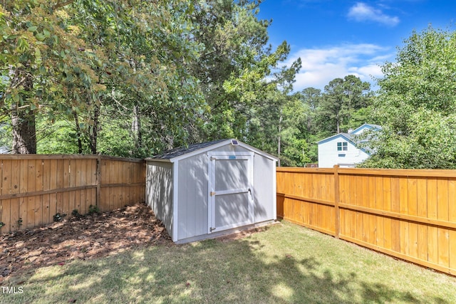 view of shed with a fenced backyard