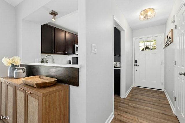 interior space with baseboards and light wood-type flooring