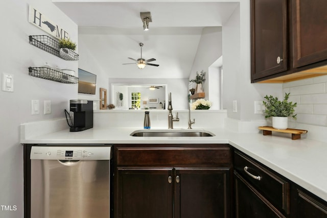 kitchen featuring a ceiling fan, vaulted ceiling, dark brown cabinets, a sink, and dishwasher