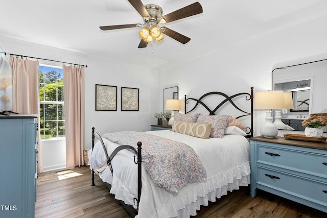 bedroom with ceiling fan and dark wood-style floors