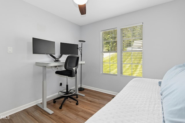 bedroom featuring baseboards, ceiling fan, and wood finished floors
