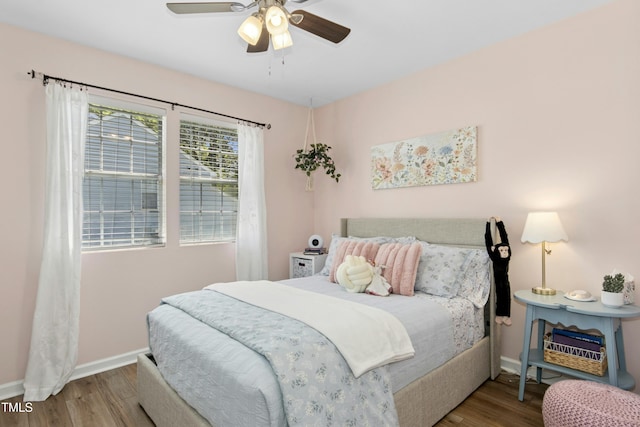 bedroom with baseboards, a ceiling fan, and wood finished floors
