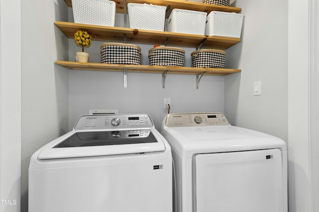 laundry room with laundry area and washing machine and clothes dryer