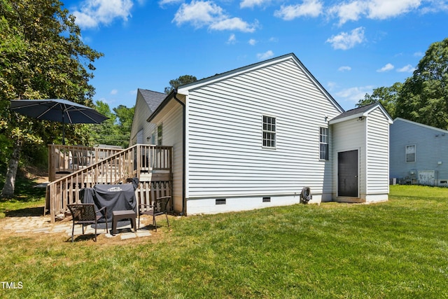 view of property exterior with a lawn, stairway, crawl space, and a deck