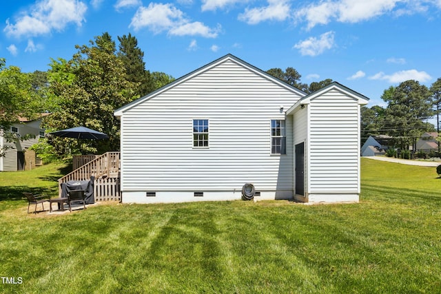 view of property exterior featuring a wooden deck, a yard, and crawl space